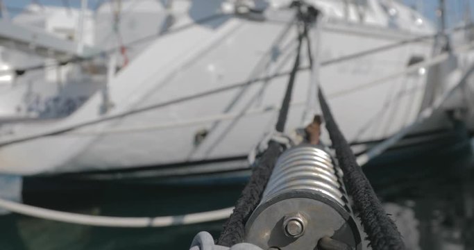 Mooring rope close up. Yacht harbor and ships at anchor.