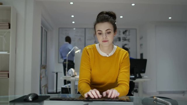  Young woman working on computer in creative office