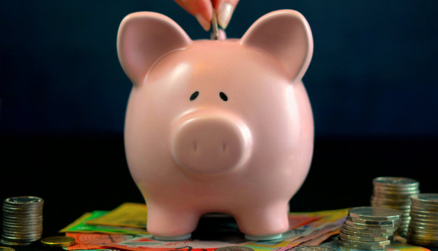 Pink Piggy bank money concept on dark blue background
