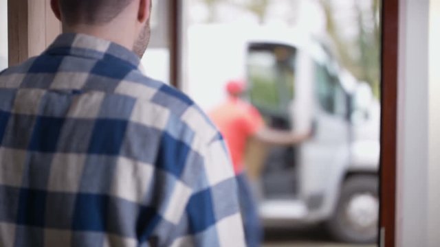  Clumsy delivery driver almost drops parcel before delivering to customer