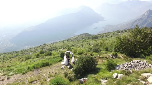 A wedding in the mountains. The wedding ceremony atop Mount Lovcen with panoramic views of the Bay of Kotor in Montenegro. Aerial Photo drone.