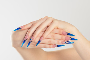 Nail Polish. Art Manicure. Modern style blue Nail Polish. Cropped horizontal image Beauty hands...