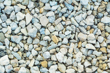 Background of many small stones of different colors, gravel or crushed stone close-up texture