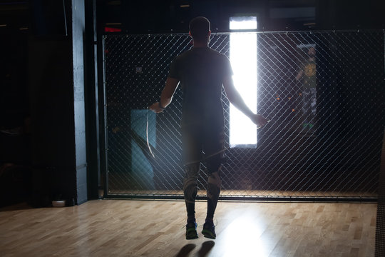 Muscular man skipping rope