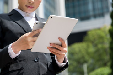 woman holding smart phone and tablet PC 