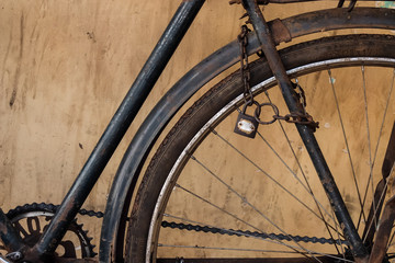 Old rusty bicycle with chain and lock on the wheel
