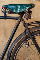 Old rusty bicycle with chain and lock on the wheel