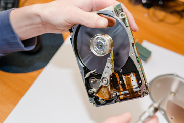 The man repairs a hard drive.