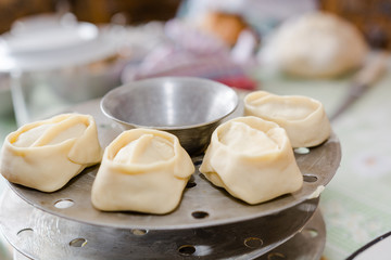 The woman molds manti. Cooking of the house, home-made food, food.