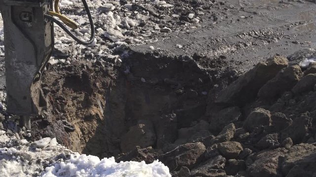 Breaker (hydraulic) cuts frozen soil Timelapse stock footage video