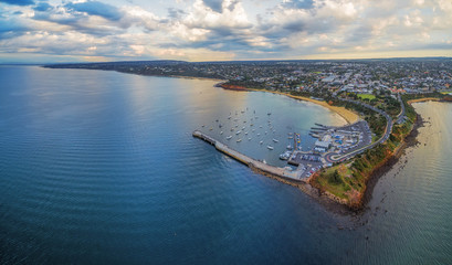 Aerial panoramic view of Mornington Pier and Peninsula coastline, showcasing the yacht club, moored...