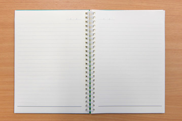 Notebook paper with on wooden background