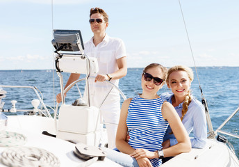 Group of happy friends traveling on a yacht. Tourism, vacation, holiday, concept.