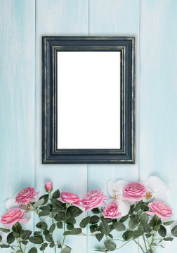Wooden background with frames, roses and orchid flowers