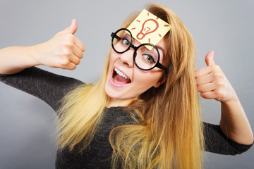 Woman having light bulb mark on forehead thinking