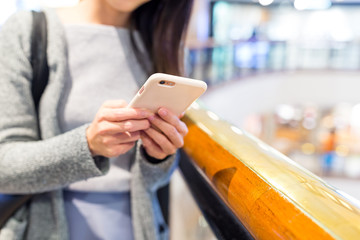 Woman use of mobile phone at shopping mall