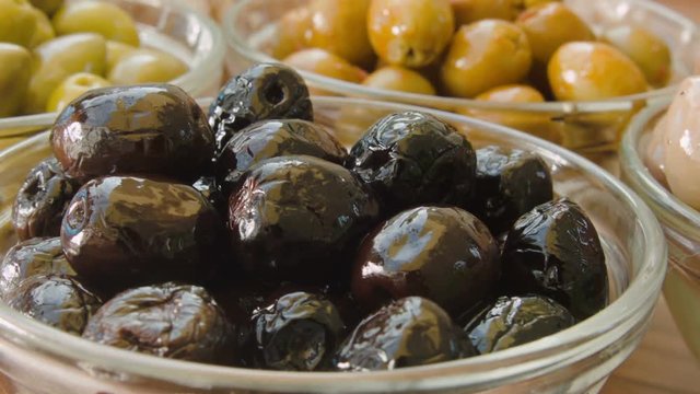 Close-up of black olives in glass bowl.