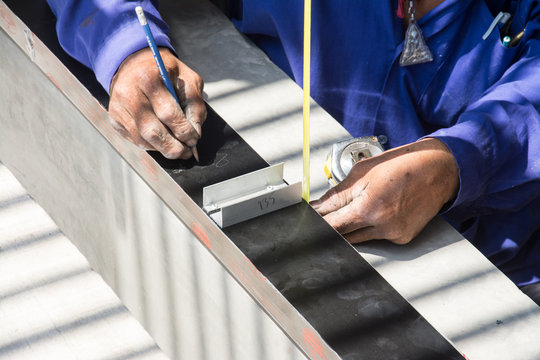 worker with measuring tape and aluminium frame