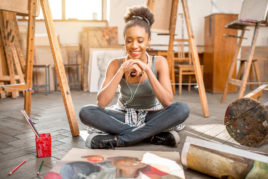 Portrait of a young african ethnicity student with still life painting at the university studio