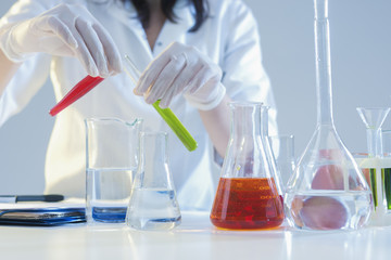 Research and Science Concepts. Closeup of Hands of Female Laboratory Staff Working With Liquids Specimens in Flasks in Laboratory During Experiment.