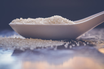 closeup of sugar on white spoon