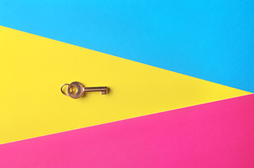Golden key on a multicolored background