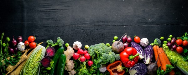 Big set organic food. Fresh raw vegetables. On a black chalkboard.