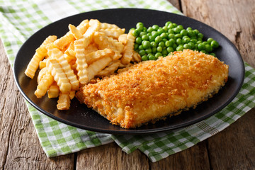 Delicious cod fish and chips with peas close-up on a plate. horizontal