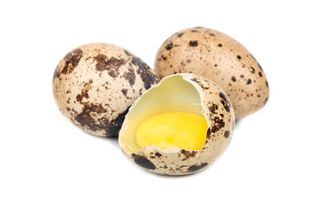 Quail egg broken on a white background