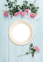 Wooden background with frame, roses and orchid flowers