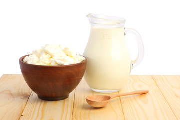 Glass jug pitcher of fresh milk with glass and cottage cheese isolated on white background carafe