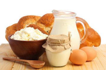 Glass jug pitcher of fresh milk with glass, eggs and cottage cheese isolated on white background carafe