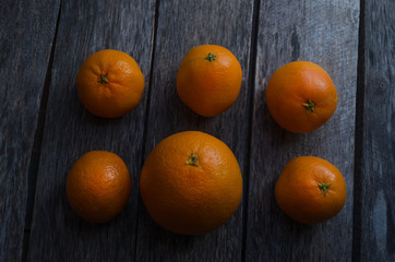 Tangerines and oranges on wooden background
