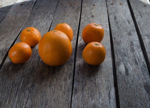 Tangerines and oranges on wooden background