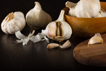 Garlic. Garlic Cloves and Garlic Bulb in wooden bowl.