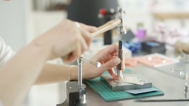 Jewelry designer working in studio, creating unique handmade pieces