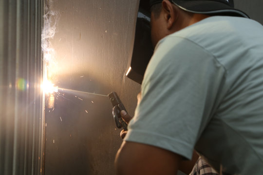 Man at work - welding metal details 
