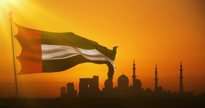 animation waving fabric texture of the flag with color of united arab emirates at sunset with sun rays light, uae on mosque silhouette in background