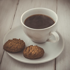 Cup of hot espresso and cookies