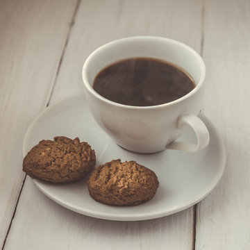 Cup of hot espresso and cookies