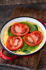 Baked omelet with cheese, spinach and tomatoes