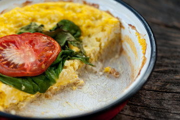 Baked omelet with cheese, spinach and tomatoes