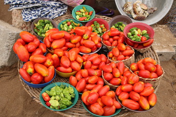 Red Tomatoes / Vendor selling fresh tomatoes at the beach of Avepozo, Togo, West Africa