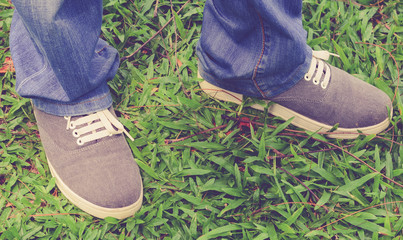 Man wear shoes on green yard