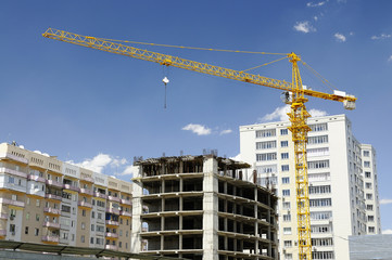 Fototapeta na wymiar House building, construction crane
