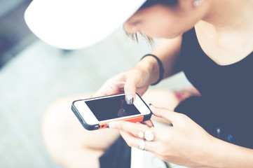 Close-up of female hands using modern smart phone while working,Young woman using a touchscreen...
