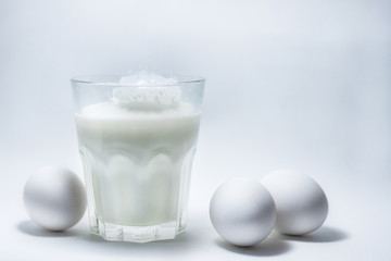 Milk in a glass jar and eggs