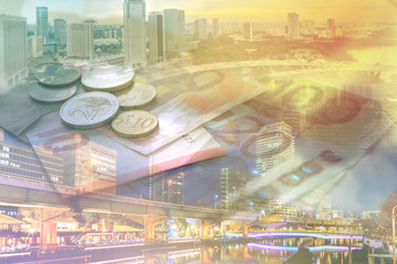 Double exposure of city, banknote and coins money for finance and business concept