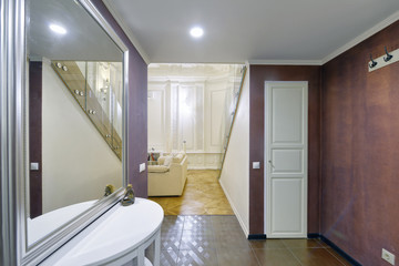 Classic interior design duplex apartment with white wall and ceiling moldings.The interior of the...