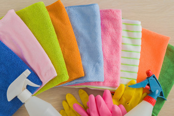 Colorful microfiber rags, rubber gloves and other window cleaning equipment. Early spring windows cleaning. Maid cleans window.